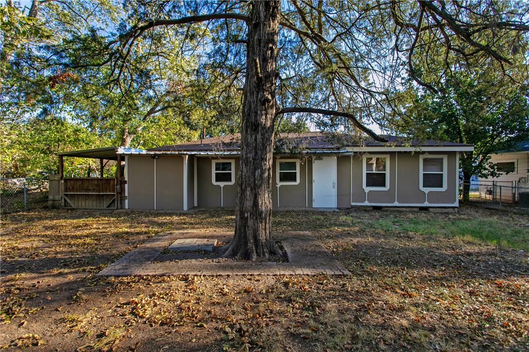 903 Travis Street Bryan, TX 77803 - Photo 18 of 20 a front view of a house with garden