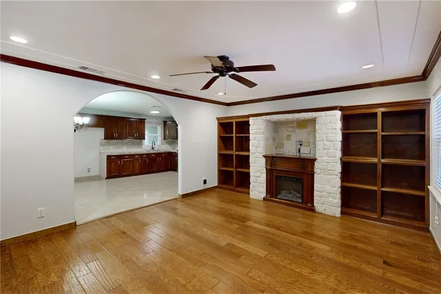 a view of an empty room with a fireplace and a window