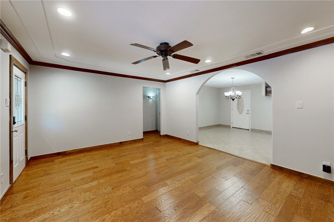 903 Travis Street Bryan, TX 77803 - Photo 4 of 20 wooden floor in an empty room with a window