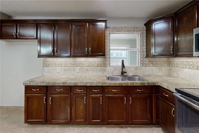 a kitchen with a sink and cabinets
