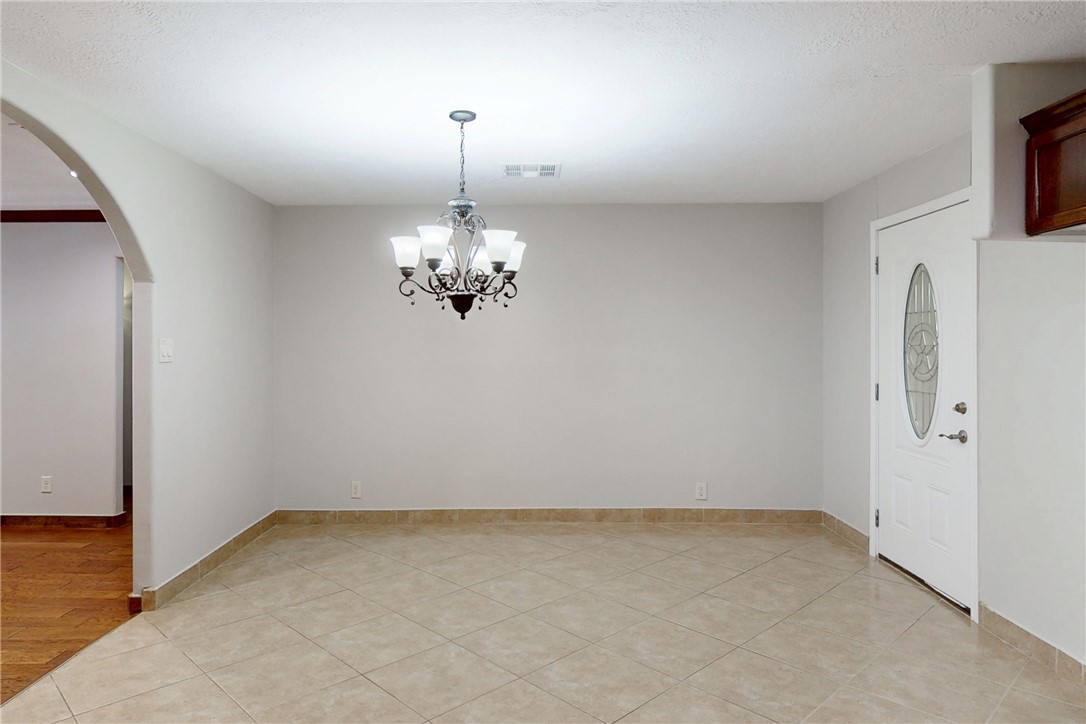 903 Travis Street Bryan, TX 77803 - Photo 8 of 20 a view of a room with steel appliances and chandelier