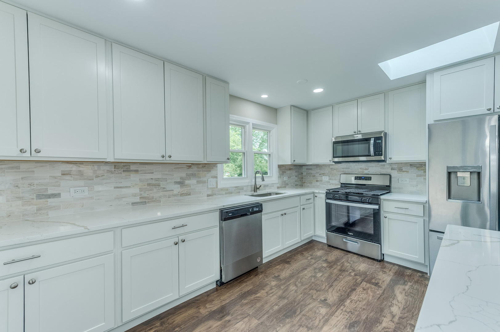 16539 Timberview Drive Plainfield, IL 60586 - Photo 11 of 26 a kitchen with stainless steel appliances granite countertop a sink a stove a refrigerator and cabinets