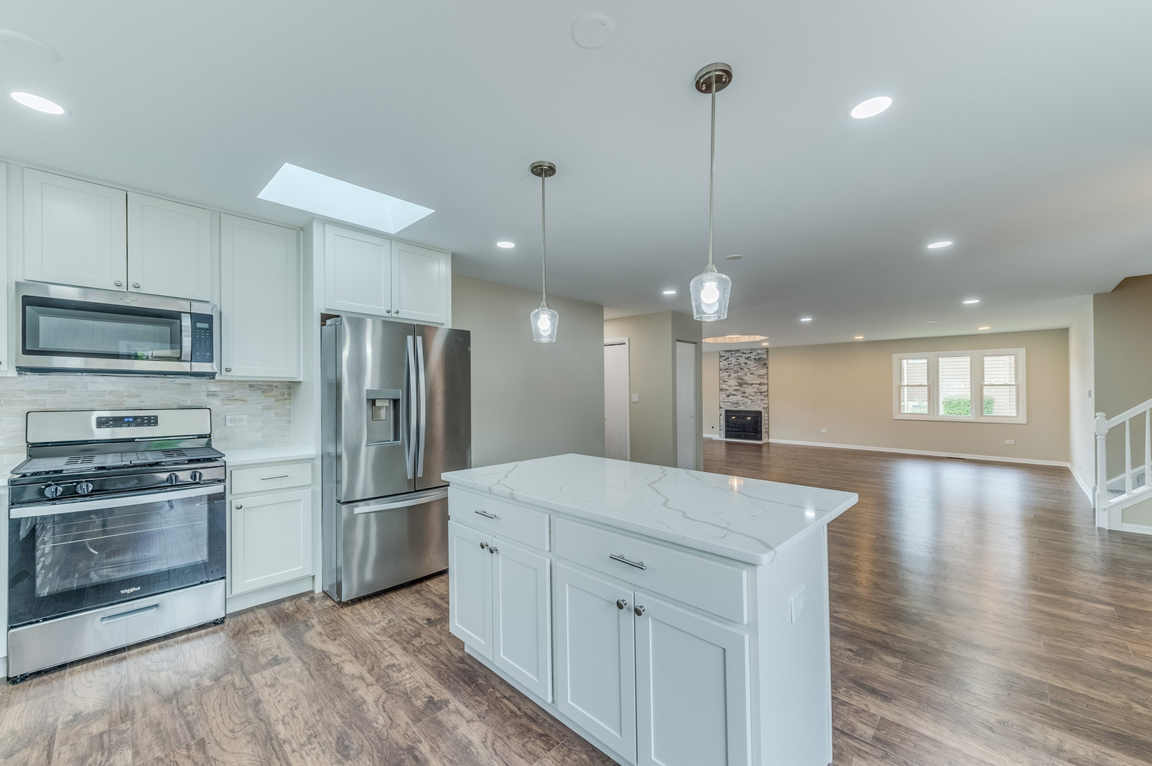 16539 Timberview Drive Plainfield, IL 60586 - Photo 12 of 26 a kitchen with a refrigerator microwave and stove top oven
