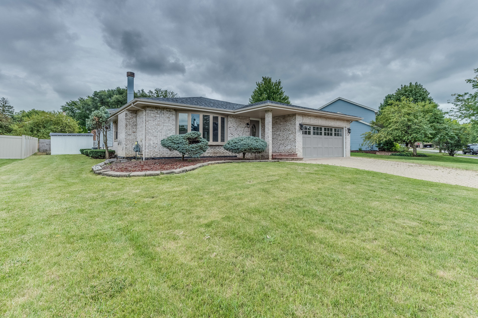 16539 Timberview Drive Plainfield, IL 60586 - Photo 2 of 26 a front view of a house with a garden
