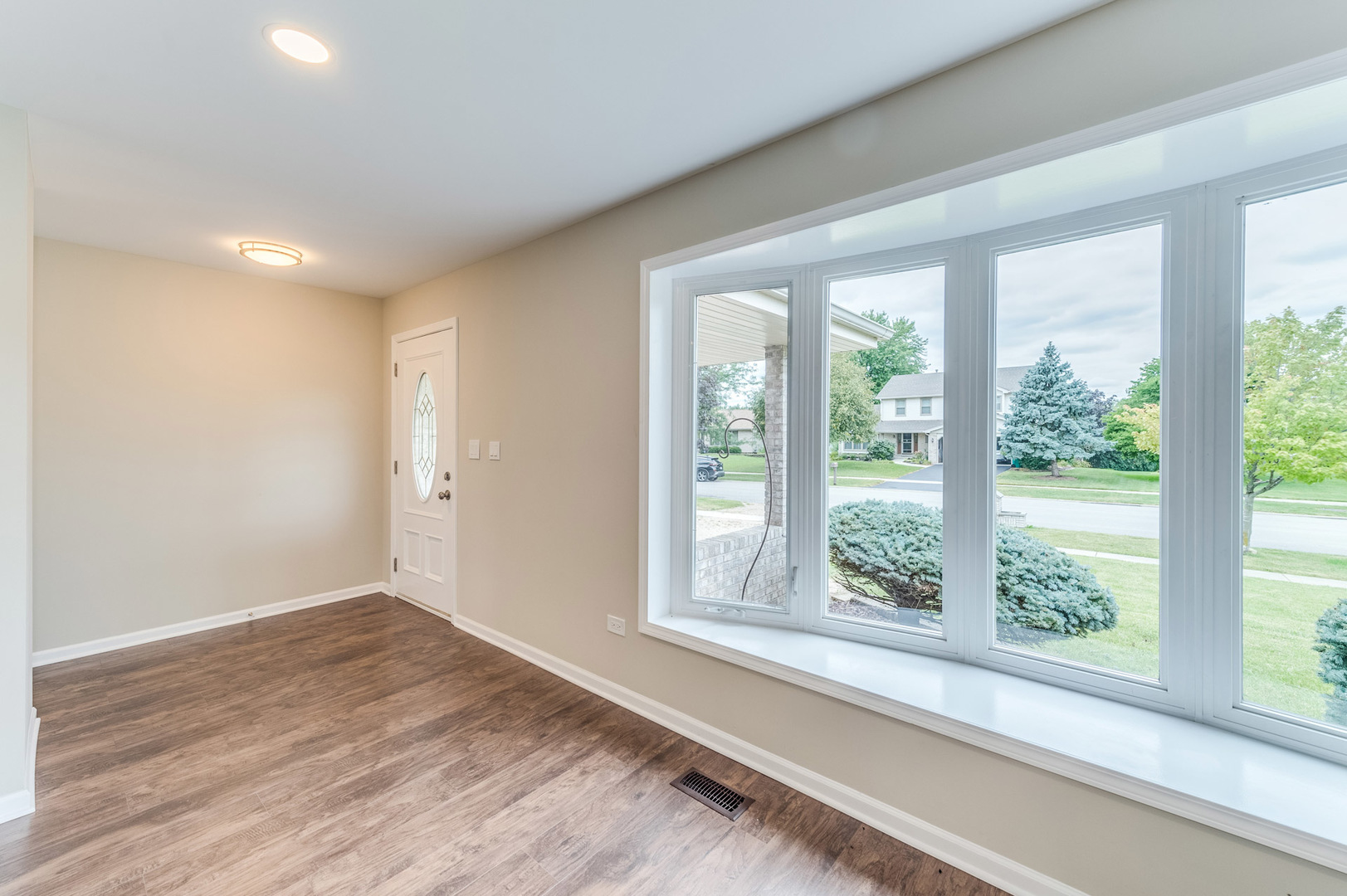 16539 Timberview Drive Plainfield, IL 60586 - Photo 3 of 26 a view of a livingroom with wooden floor and a window