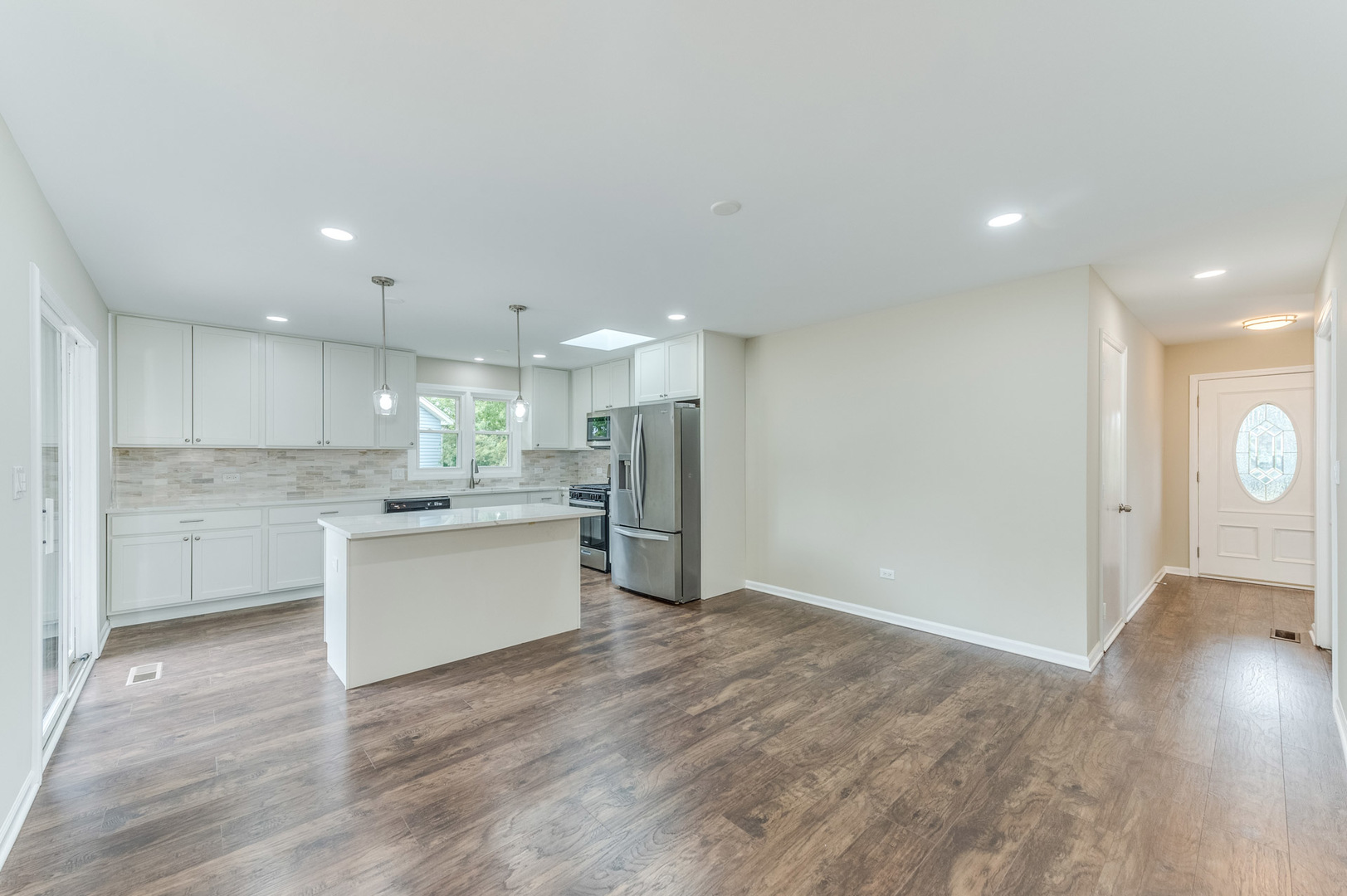 16539 Timberview Drive Plainfield, IL 60586 - Photo 9 of 26 a large kitchen with kitchen island a sink stainless steel appliances and cabinets