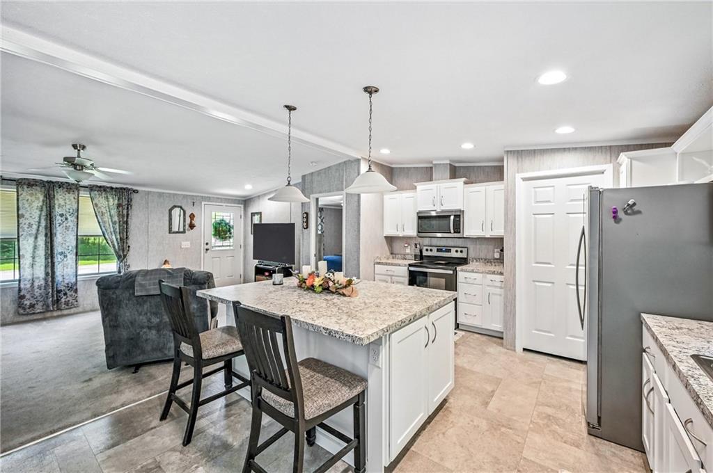 73 South Summit Road, Unit 503 Greenville, PA 16125 - Photo 6 of 36 a kitchen with a table chairs refrigerator and microwave