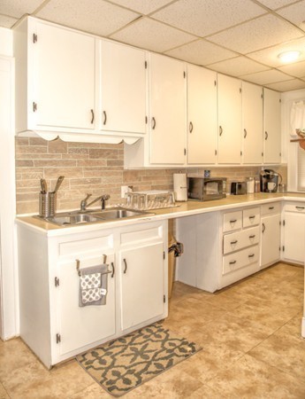 403 Page Boulevard Springfield, MA 01104 - Photo 7 of 25 a kitchen with stainless steel appliances granite countertop a sink stove and cabinets