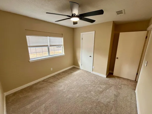 a view of an empty room and a window