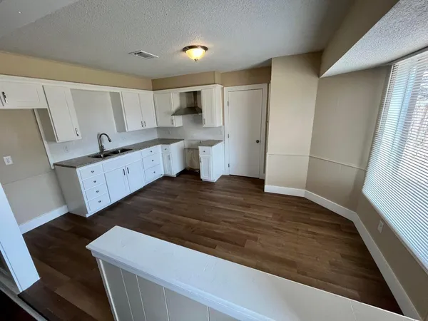a view of kitchen with sink microwave and refrigerator