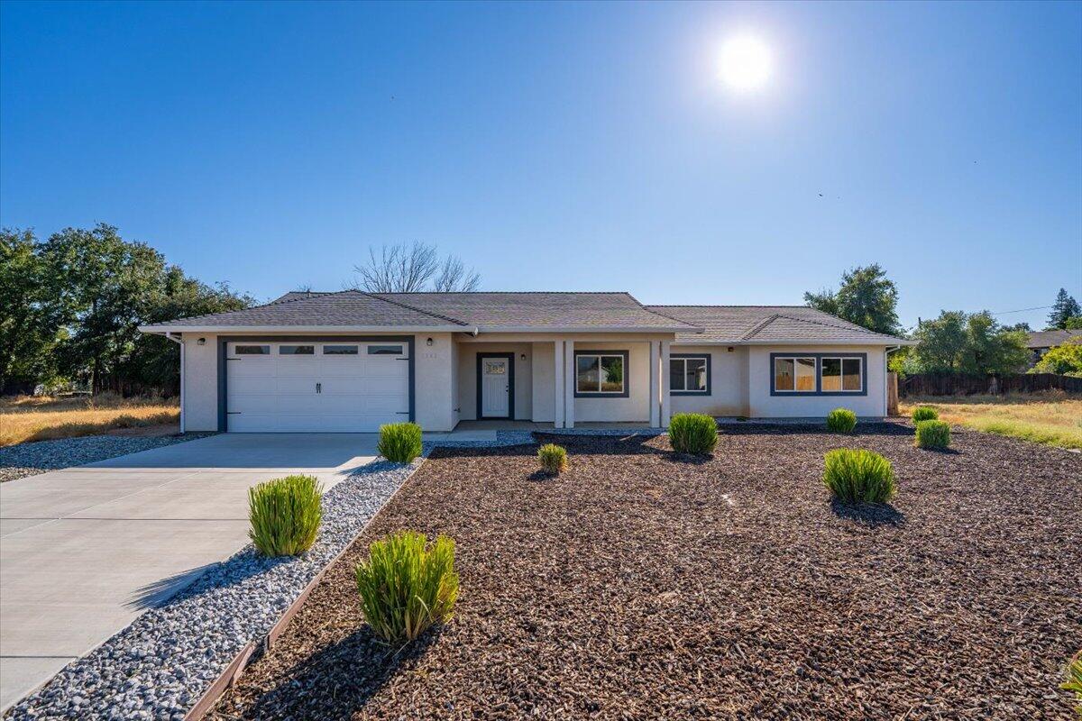 a front view of a house with garden