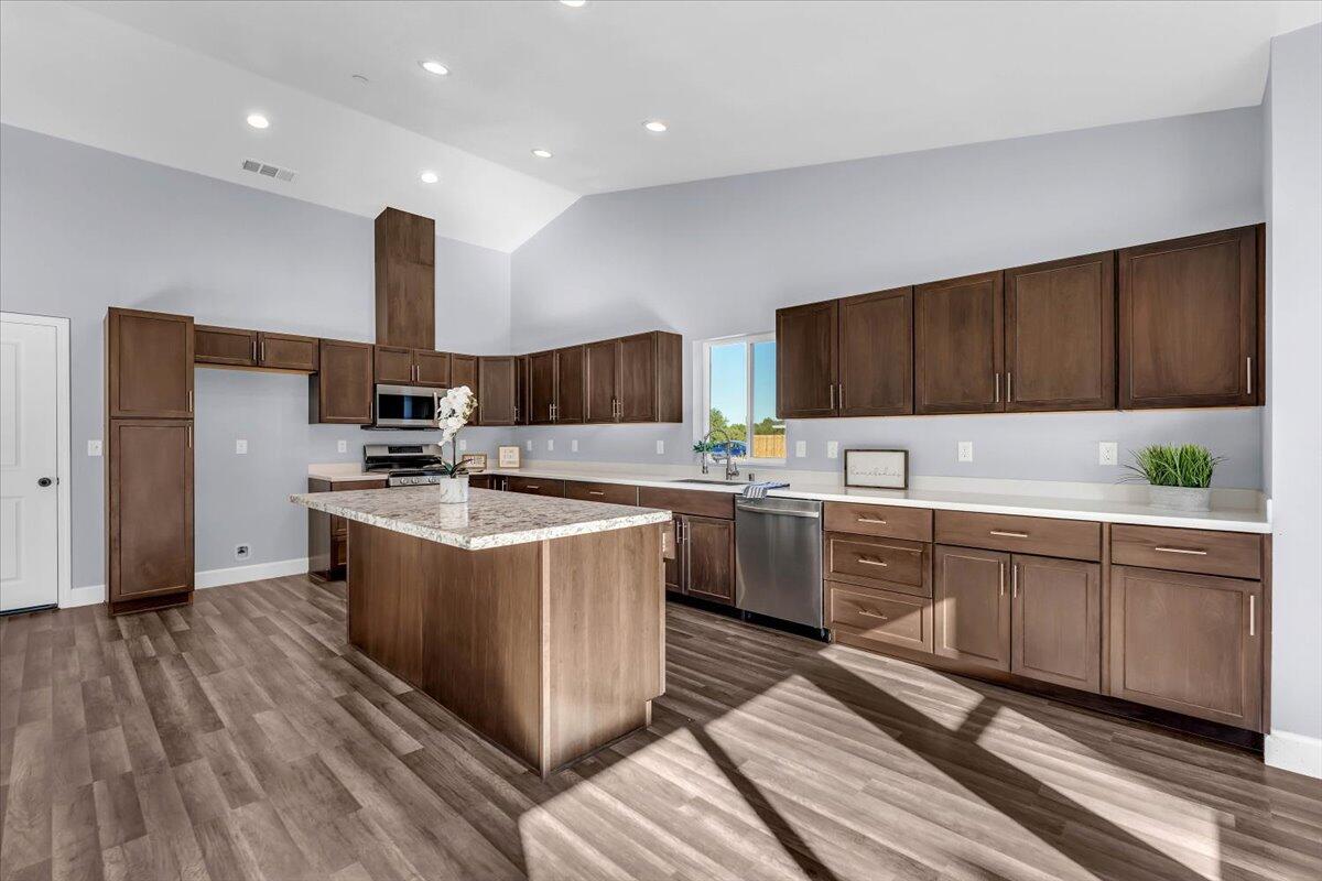 1565 Carl Court Red Bluff, CA 96080 - Photo 15 of 49 a kitchen with a sink stove and cabinets
