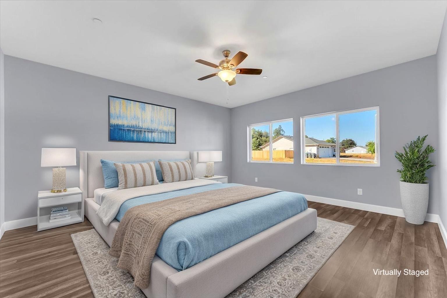 1565 Carl Court Red Bluff, CA 96080 - Photo 21 of 49 a bedroom with a large bed and a potted plant