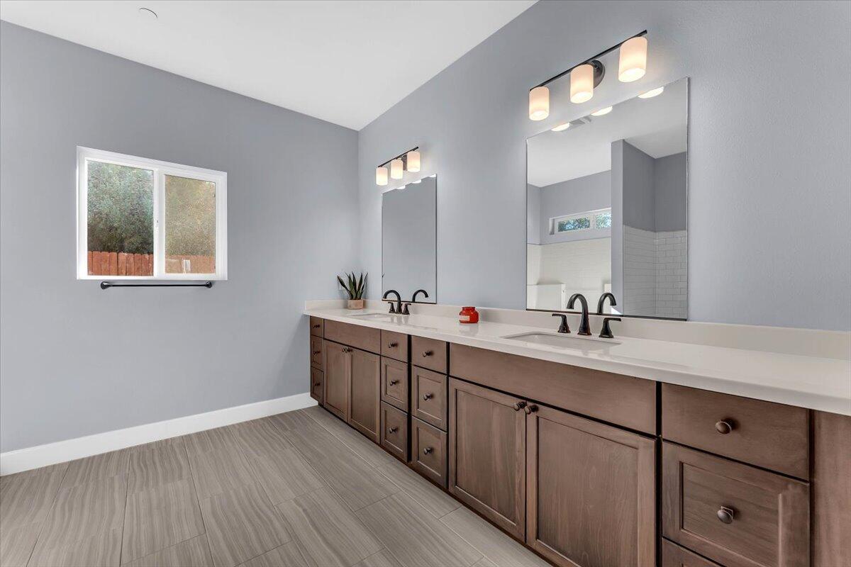 1565 Carl Court Red Bluff, CA 96080 - Photo 30 of 49 a bathroom with a double vanity sink and a mirror