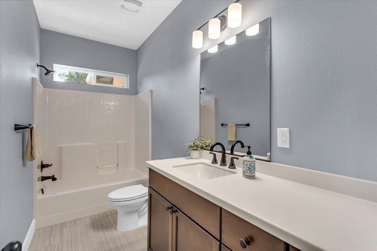 1565 Carl Court Red Bluff, CA 96080 - Photo 33 of 49 a bathroom with a sink a toilet and shower