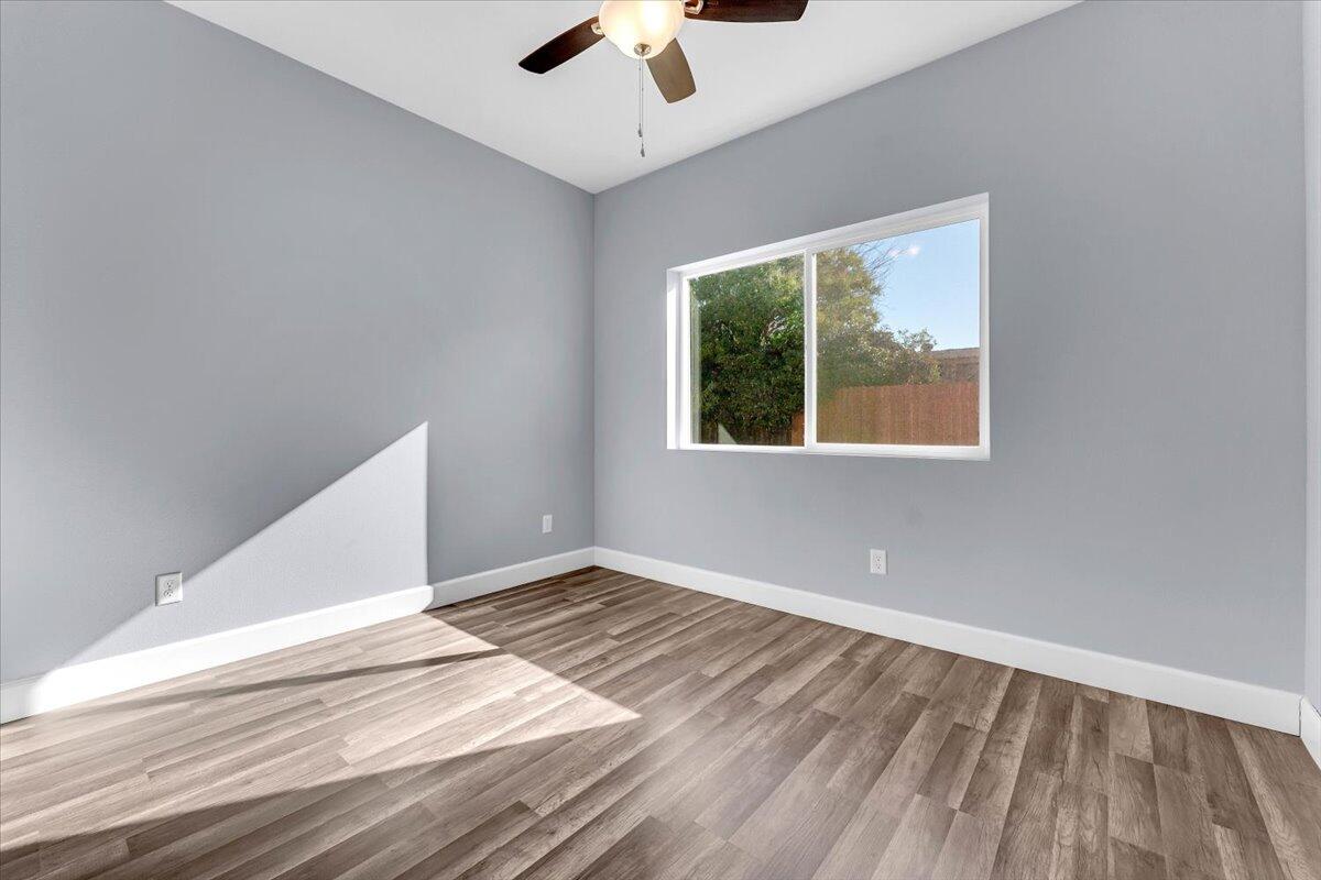 1565 Carl Court Red Bluff, CA 96080 - Photo 34 of 49 an empty room with a window and a ceiling fan