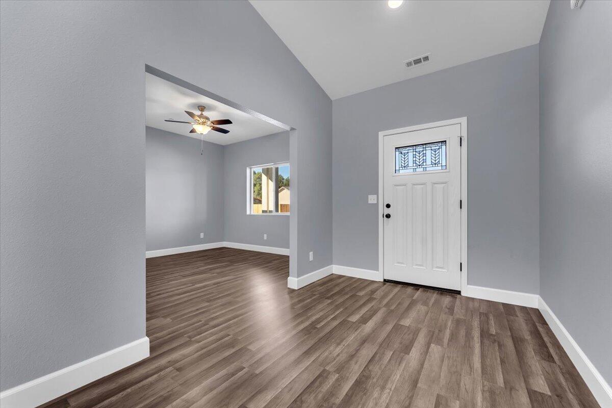 1565 Carl Court Red Bluff, CA 96080 - Photo 5 of 49 an empty room with wooden floor and windows