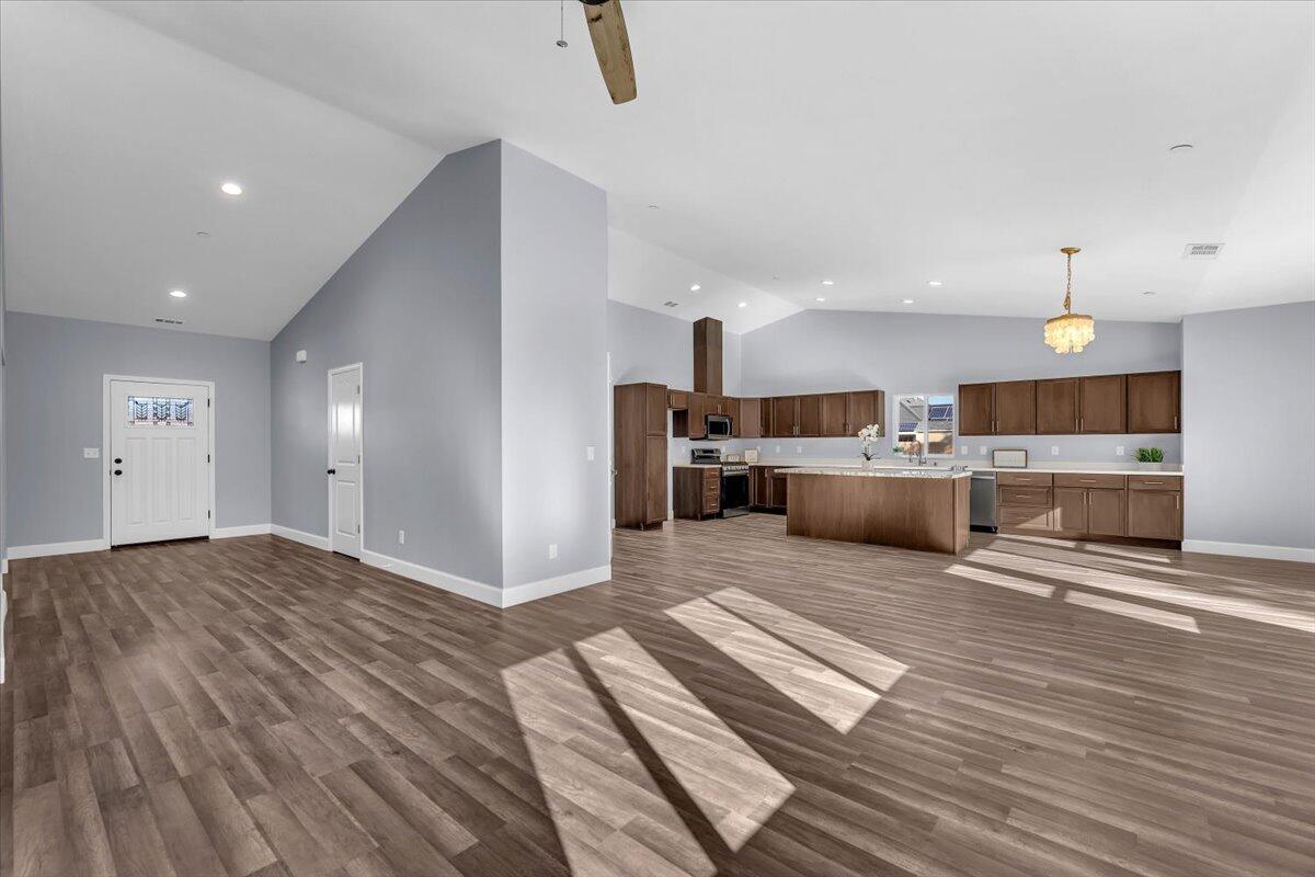 1565 Carl Court Red Bluff, CA 96080 - Photo 8 of 49 a large kitchen with a lot of cabinets and wooden floor