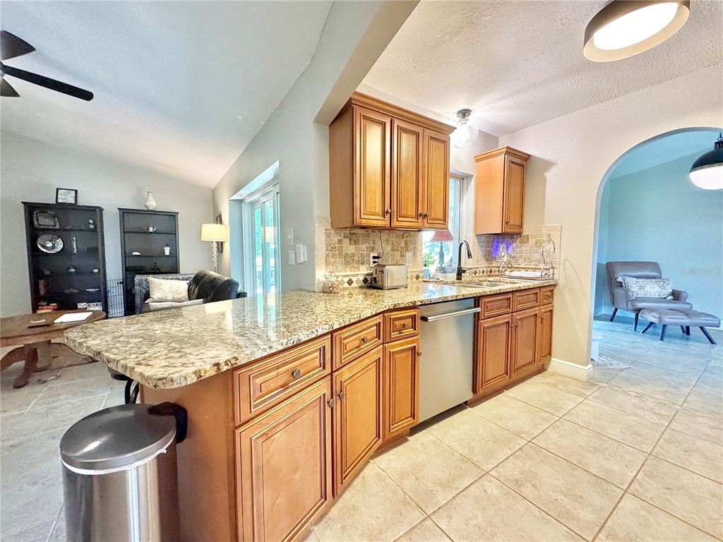 9405 Spring Circle Port Charlotte, FL 33981 - Photo 8 of 24 a kitchen with stainless steel appliances granite countertop a sink dishwasher stove and cabinets