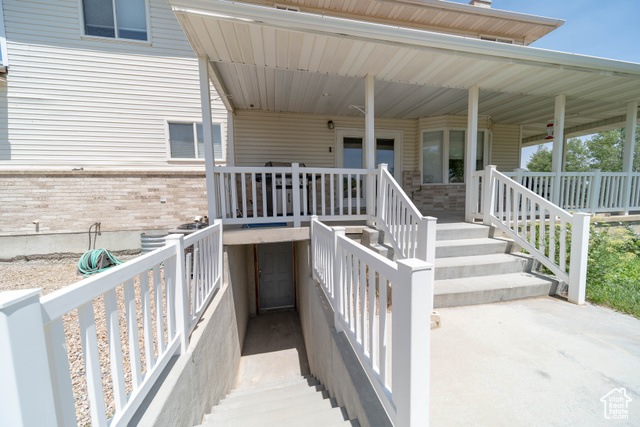 190 600 North Ferron, UT 84523 - Photo 64 of 85 Property entrance with brick siding and covered porch from the rear of the home