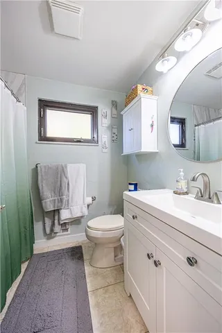 a bathroom with a sink a toilet and mirror