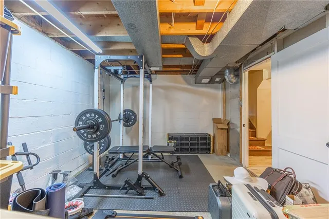 a room with lots of white furniture and wooden floor
