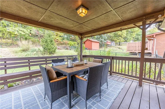 a view of a patio with a table and chairs