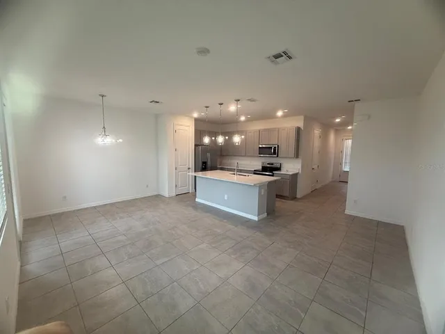 a view of a big room with windows and closet