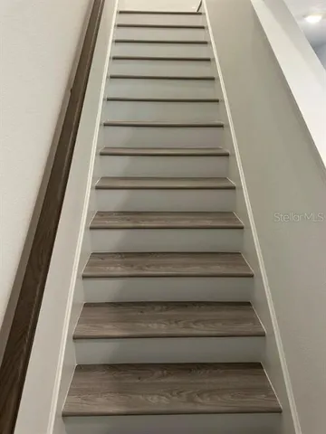 a view of a room with wooden floor and window