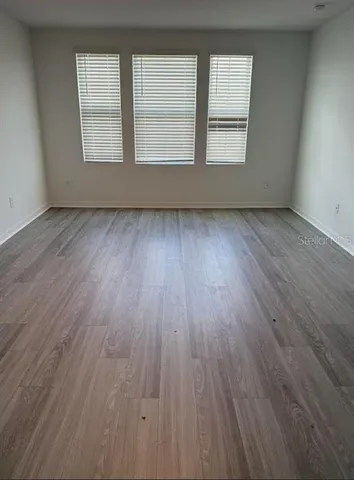 a white toilet sitting next to a white wall