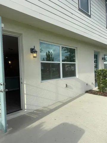 a view of a street with potted plants