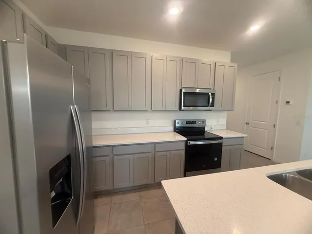 a kitchen with a sink a stove and refrigerator