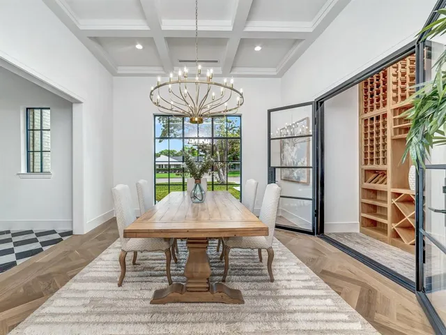 a view of a dining room with furniture a chandelier and wooden floor
