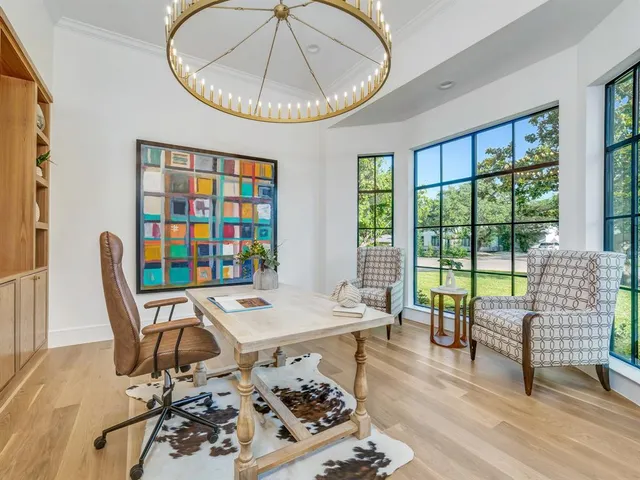 a spacious bedroom with a bed and glass door