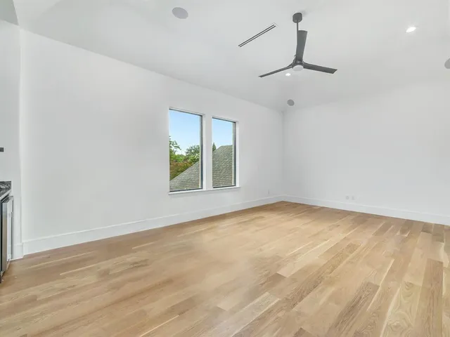 a kitchen with granite countertop white cabinets and a stove