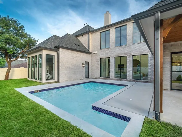 an aerial view of multiple houses with a yard