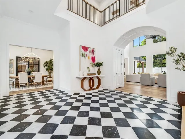 a room with a black white checkered floor and a coffee table