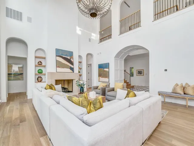 a living room with fireplace furniture and a rug