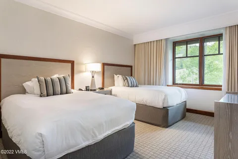 a bedroom with bed and a large window