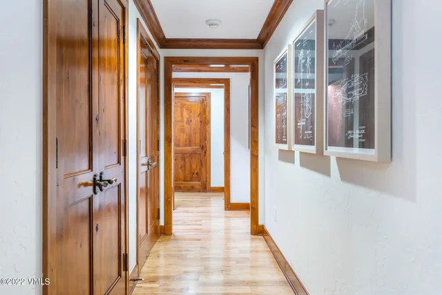 a view of a hallway with a glass door and shower