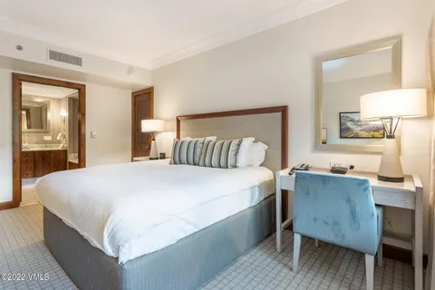 a bedroom with a bed and a table in it