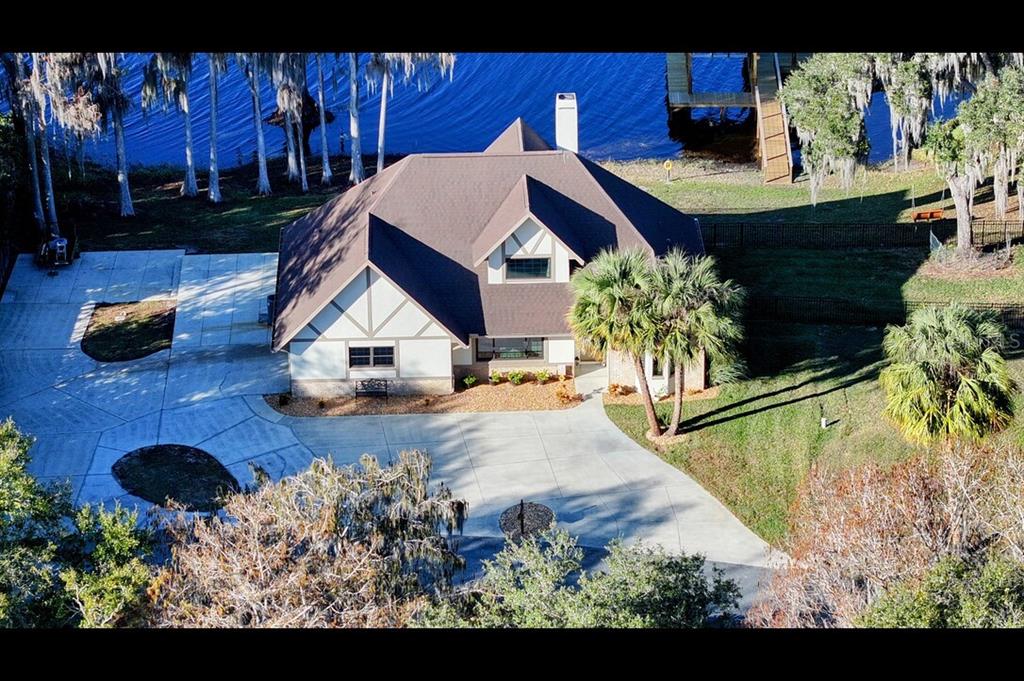 a view of a house with backyard water fountain and sitting area