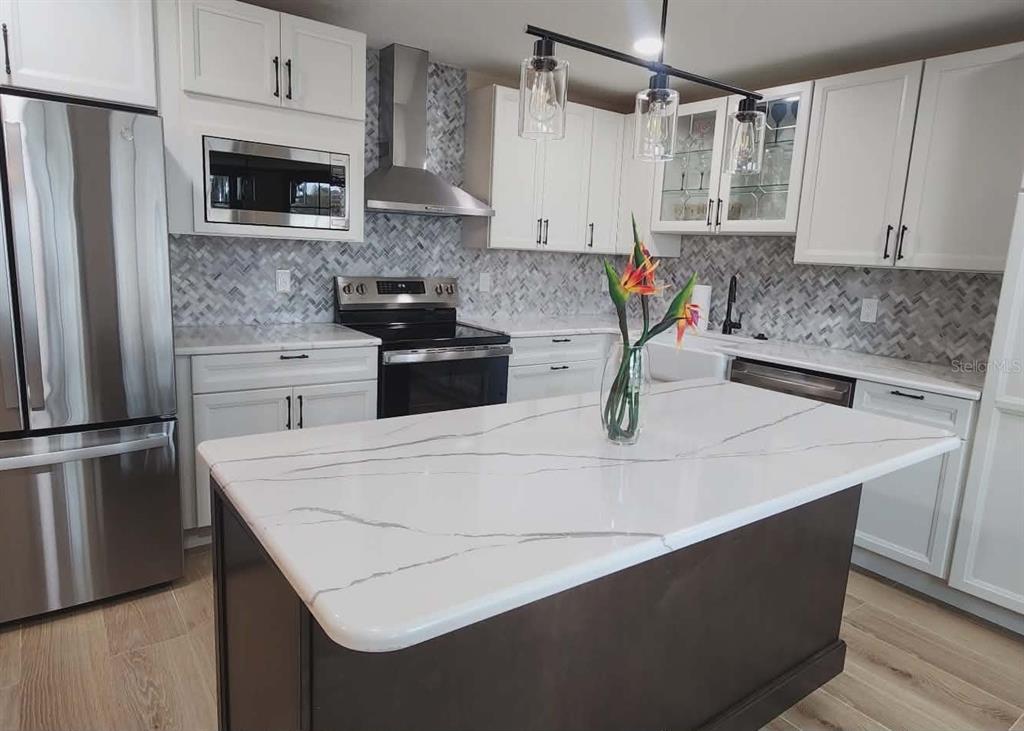1425 South Homestead Point Inverness, FL 34450 - Photo 20 of 72 a kitchen with stainless steel appliances a stove refrigerator sink and microwave