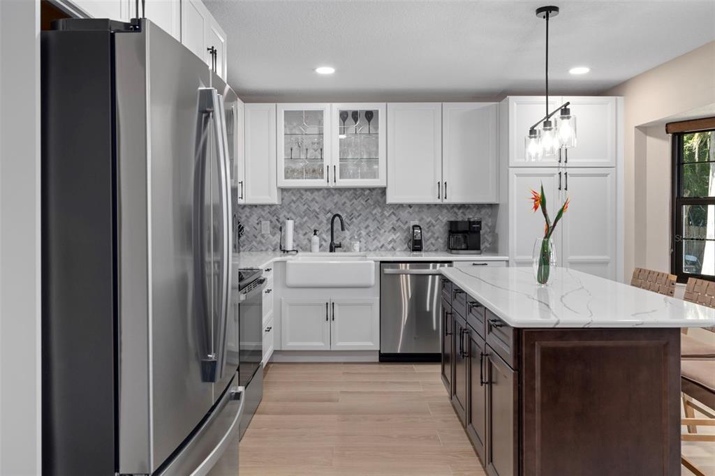 1425 South Homestead Point Inverness, FL 34450 - Photo 22 of 72 a kitchen that has a lot of white cabinets and stainless steel appliances