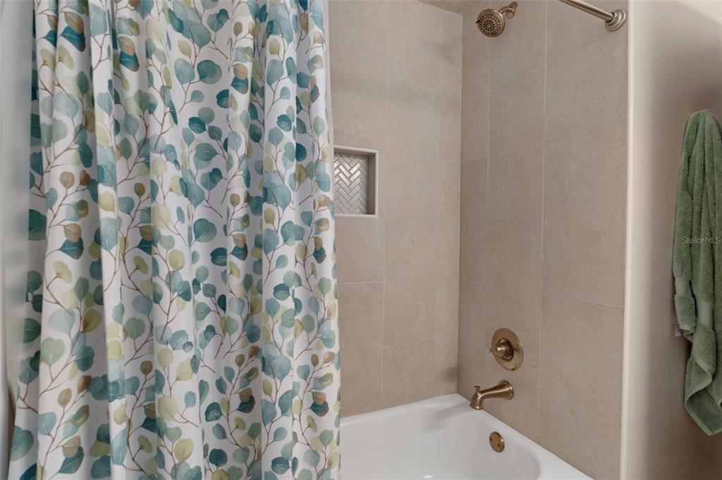 1425 South Homestead Point Inverness, FL 34450 - Photo 26 of 72 a bathroom with a bathtub and a shower curtain