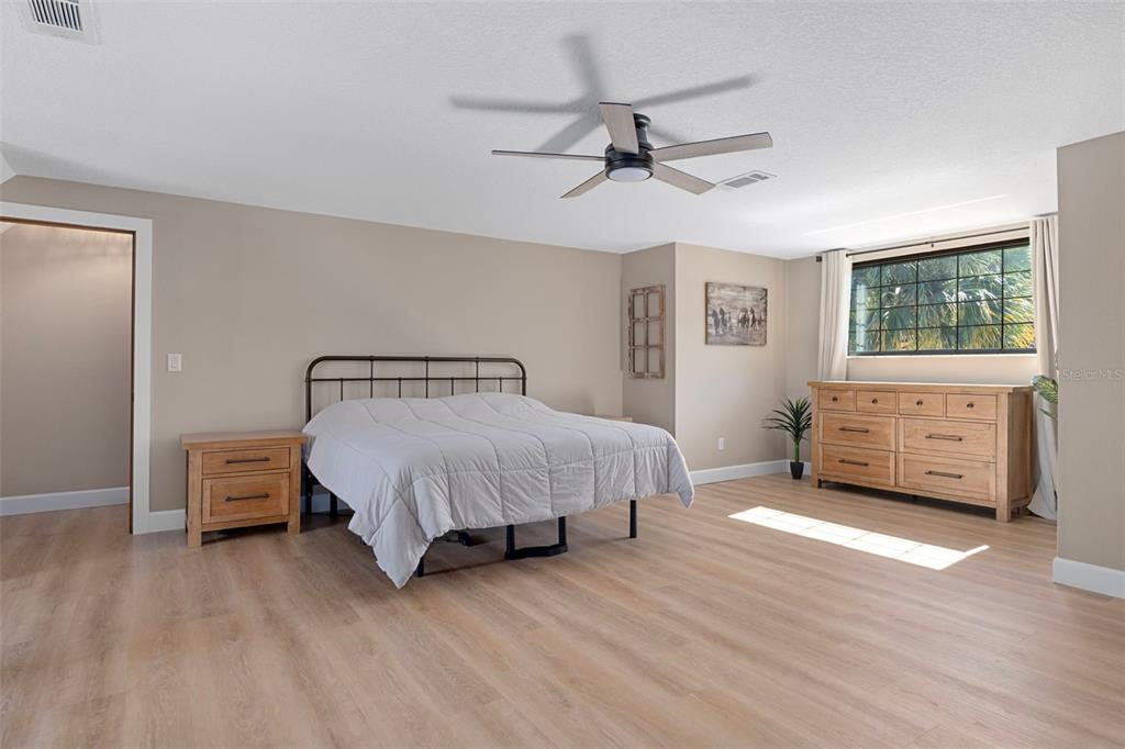 1425 South Homestead Point Inverness, FL 34450 - Photo 32 of 72 a spacious bedroom with a bed and window