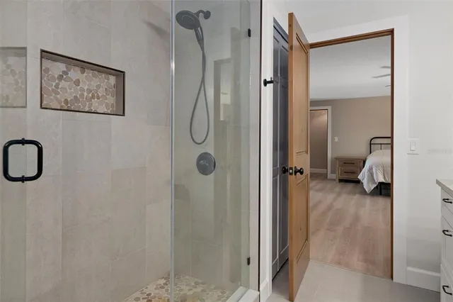 a dining room with furniture a chandelier and wooden floor