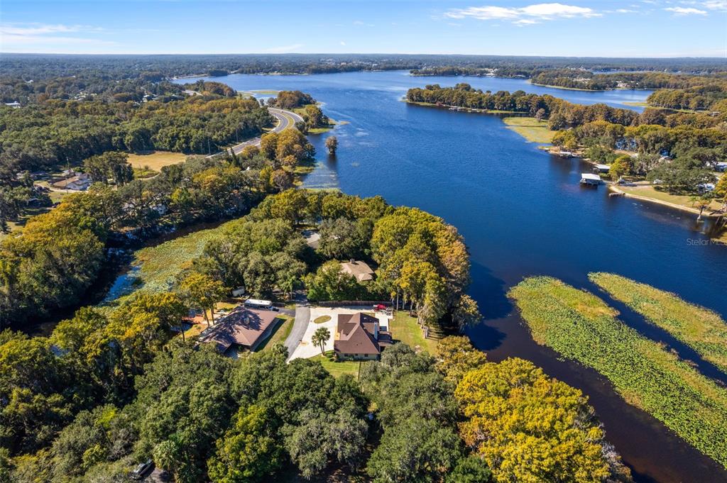 1425 South Homestead Point Inverness, FL 34450 - Photo 6 of 72 an aerial view of a house with a yard and lake view