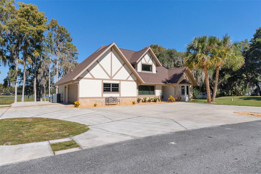 1425 South Homestead Point Inverness, FL 34450 - Photo 69 of 72 a view of a white house with a big yard and large trees