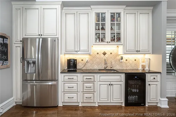 a spacious bedroom with a bed and a flat screen tv